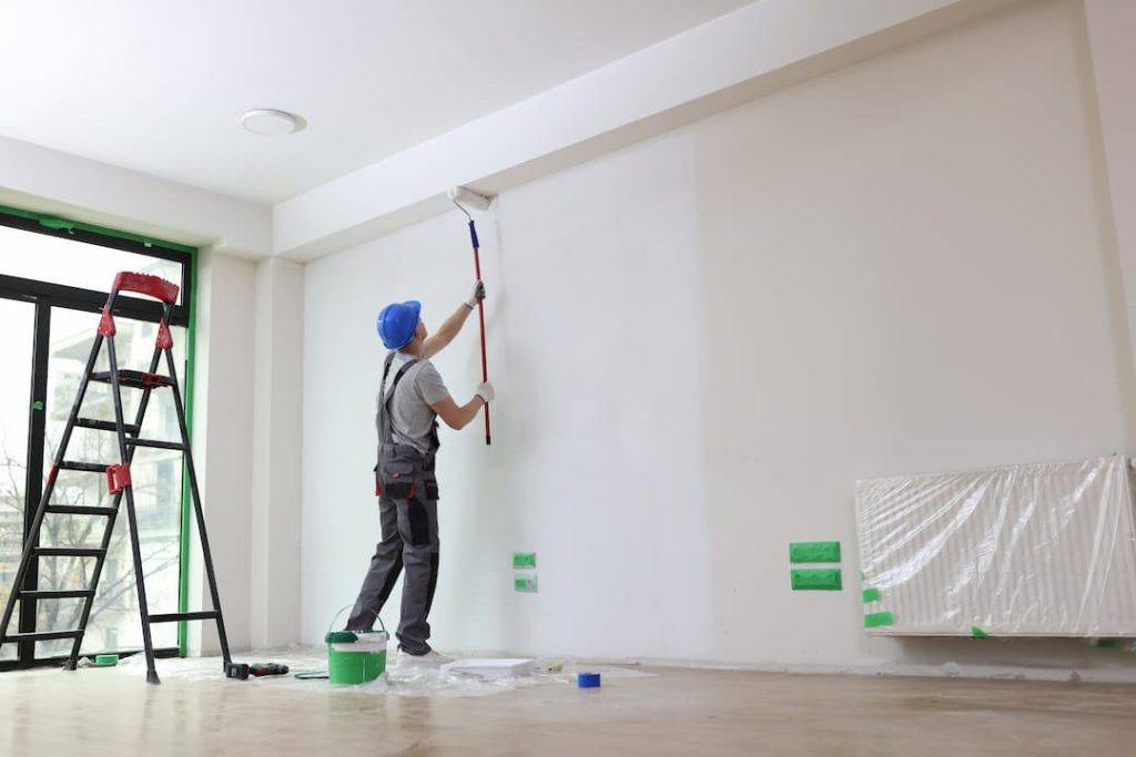 painter and decorator painting a wall